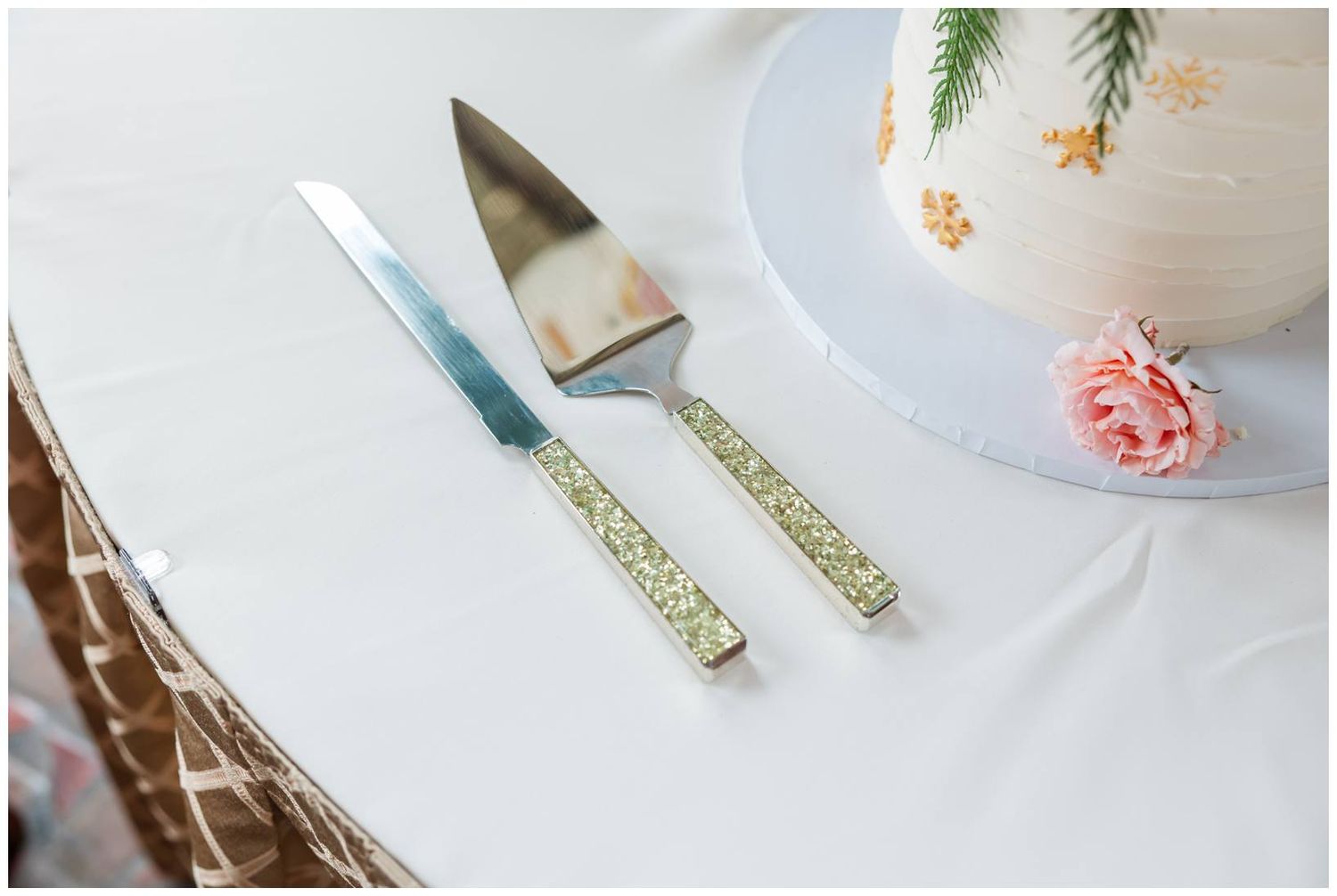 Wedding detail shots of white and gold cake serving utensils on a light background.