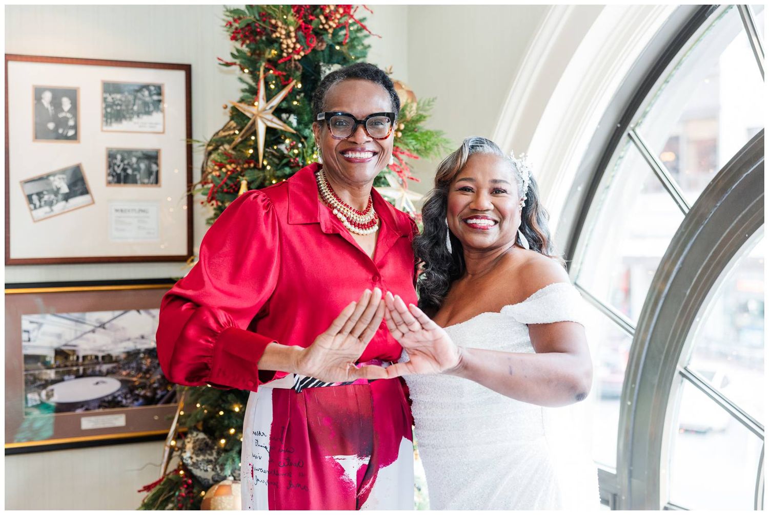 A couple shares joyful laughter and embraces during what appears to be a wedding celebration.