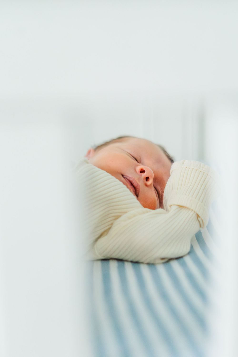 newborn baby sleeping in their crib