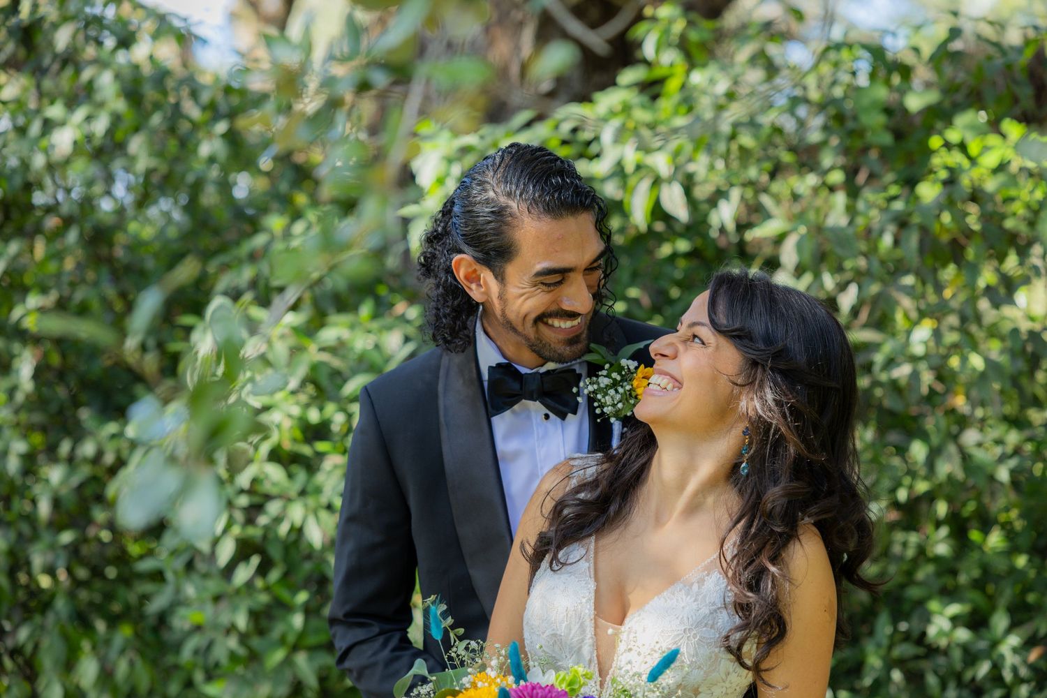 Candid moment of bride and groom smiling at each other at Long Key Natural Area & Nature Center