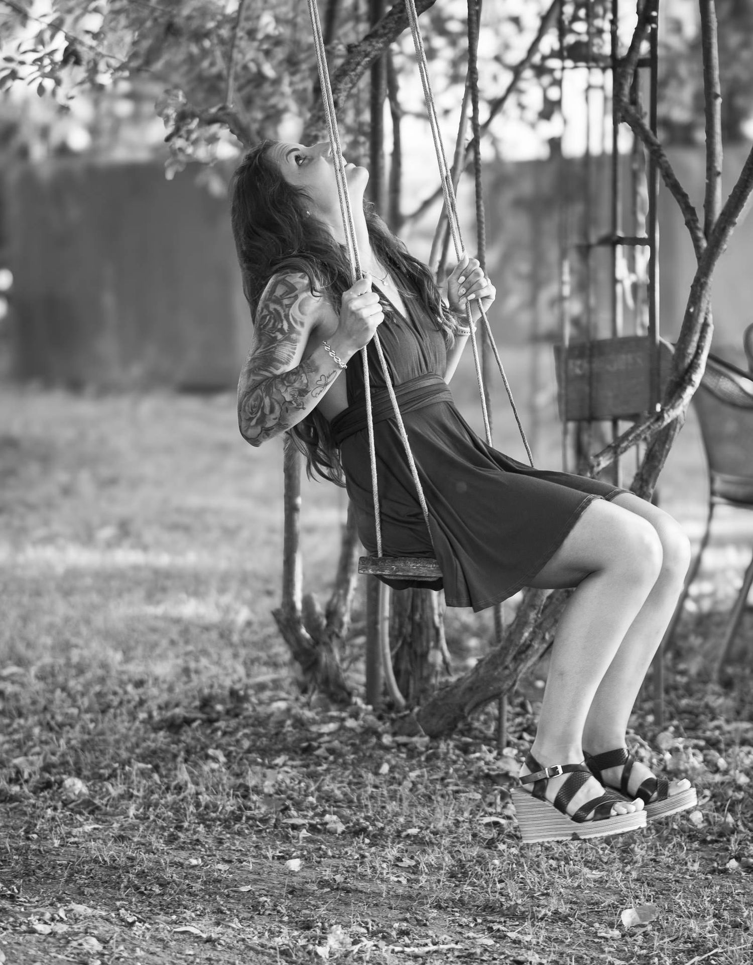 Black and white photos of children's legs swinging on playground equipment.