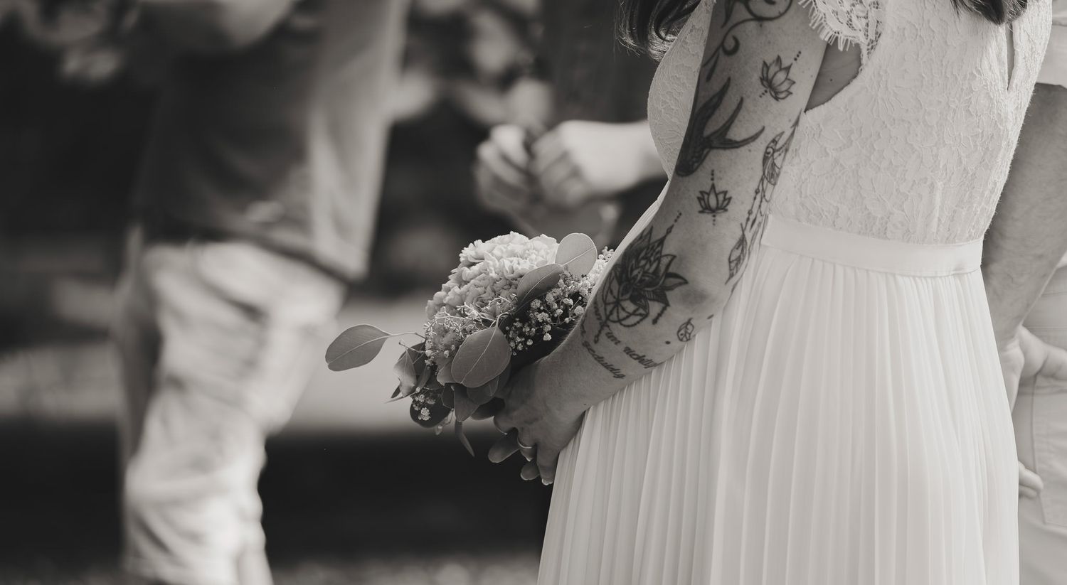 Close-up details of a white wedding dress with lace elements.
