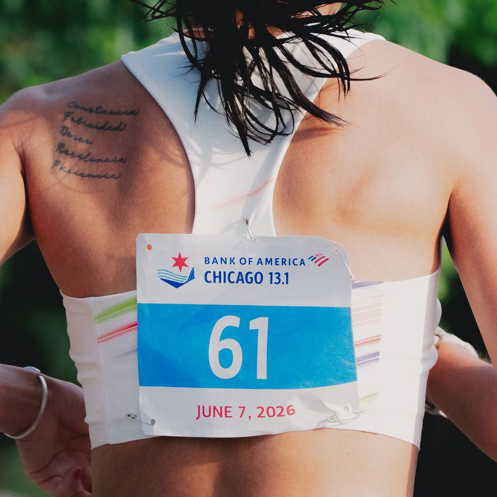 Runner wearing bib number 61 for Bank of America Chicago 13.1 half marathon on June 7, 2026, with tattoos visible.