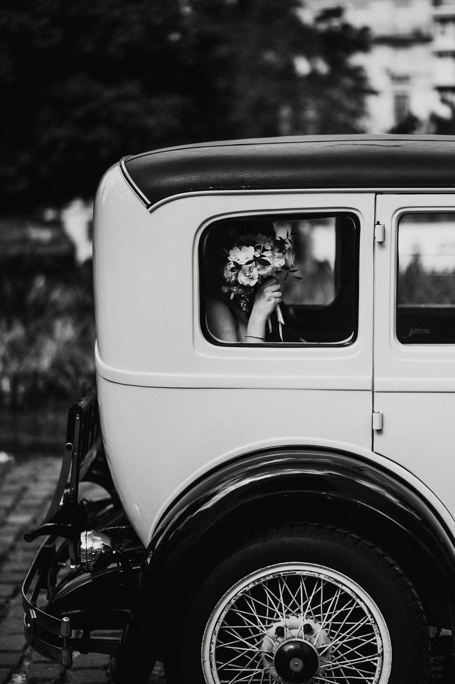 A black and white photo sequence showing different angles of a vintage car's window and wheel details.