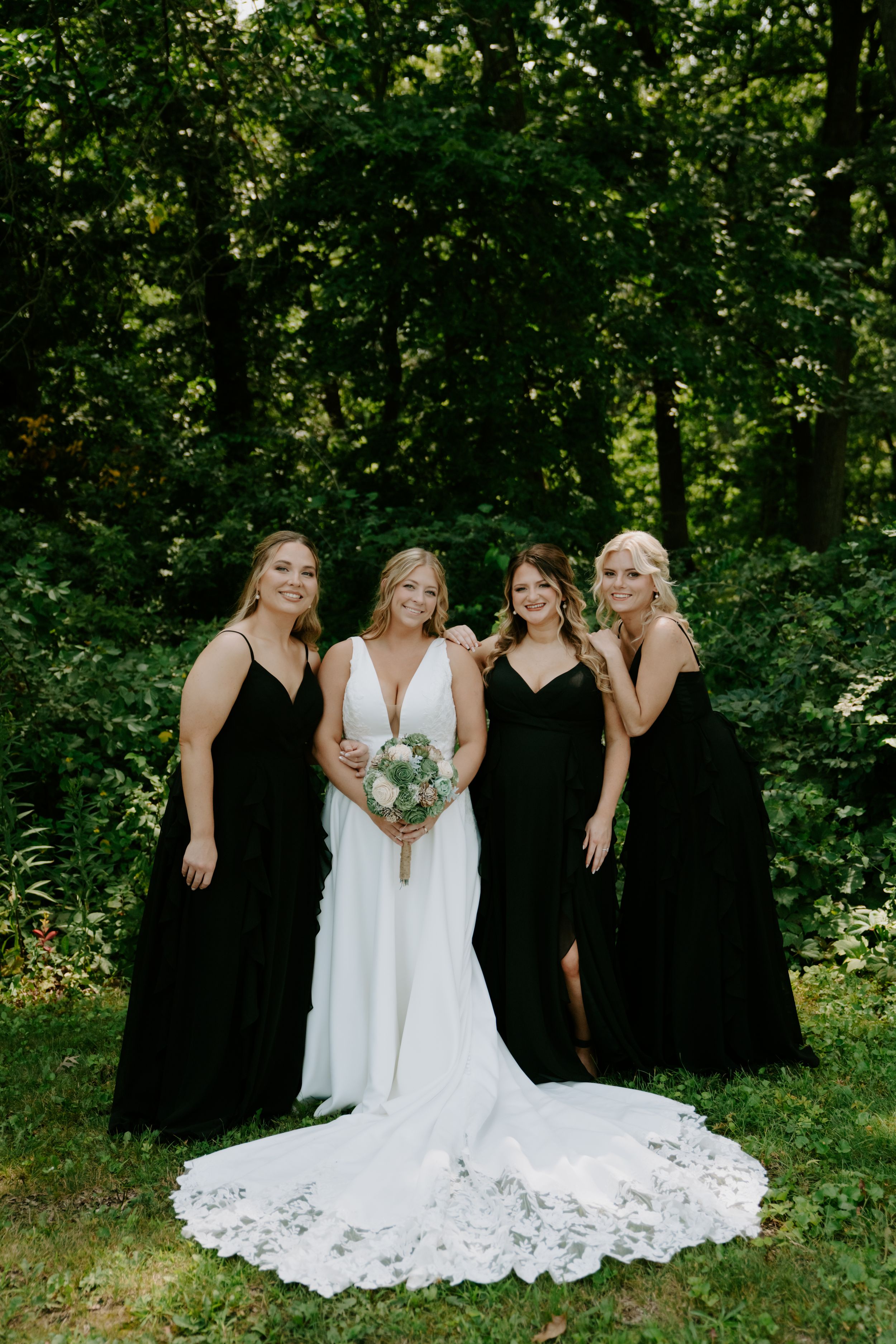 Candid moment of bridal party laughing together in a garden setting.