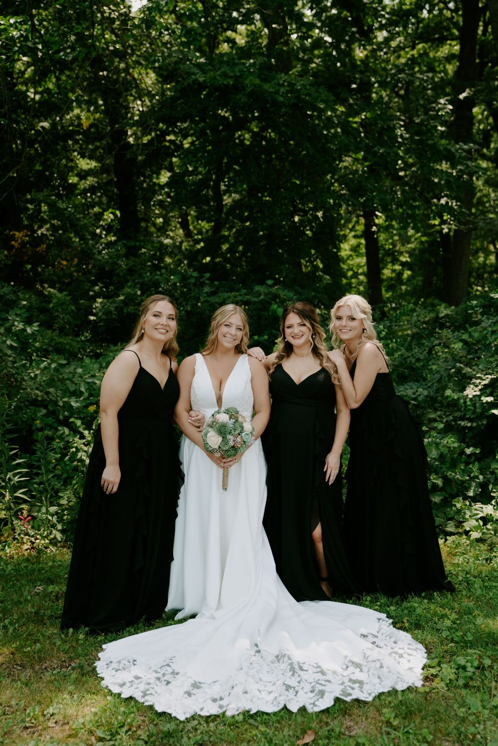 Candid moment of bridal party laughing together in a garden setting.