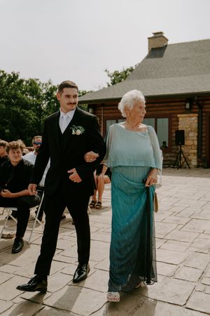 Emotional dance moment captured at outdoor wedding reception on stone patio.