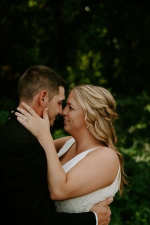 An intimate embrace between a couple during their outdoor wedding photoshoot.