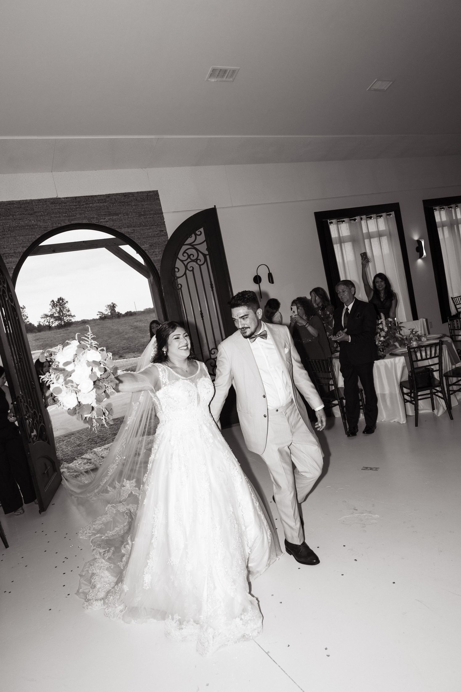 Bride and groom share a joyful dance together on the reception floor during their wedding celebration.