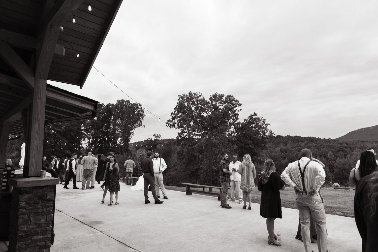Vintage black and white photographs showing scenes of visitors walking along a railed pathway in a park or tourist area.