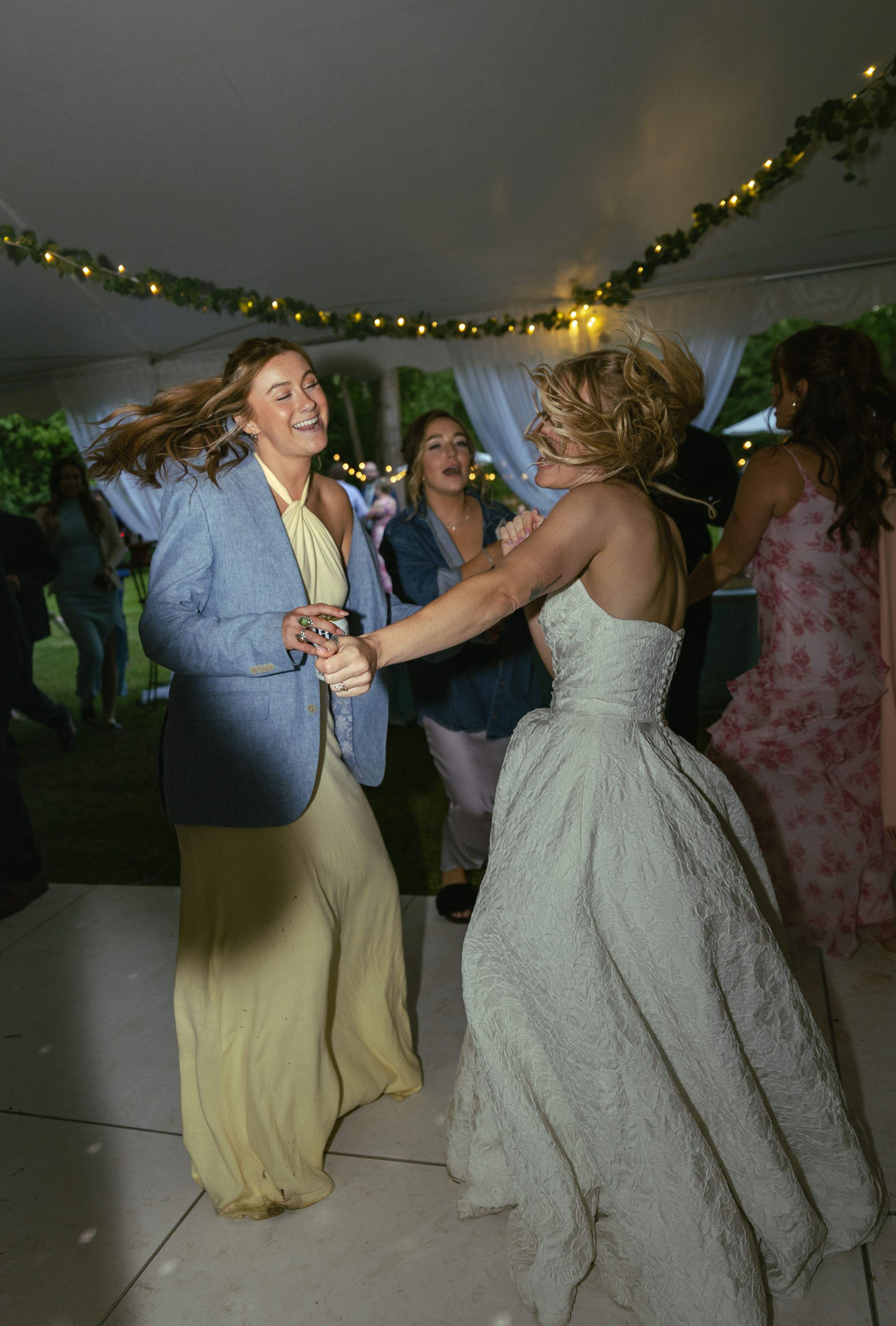 Wedding reception dance party filled with joyful moments under twinkling lights.