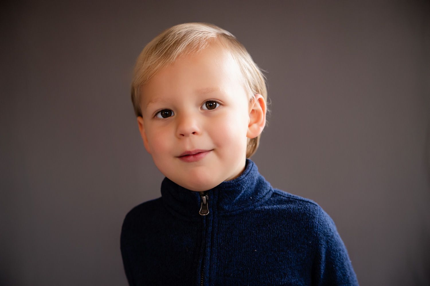 Preschool child looks at the camera during his school photo session with Cindy Tucey Photography