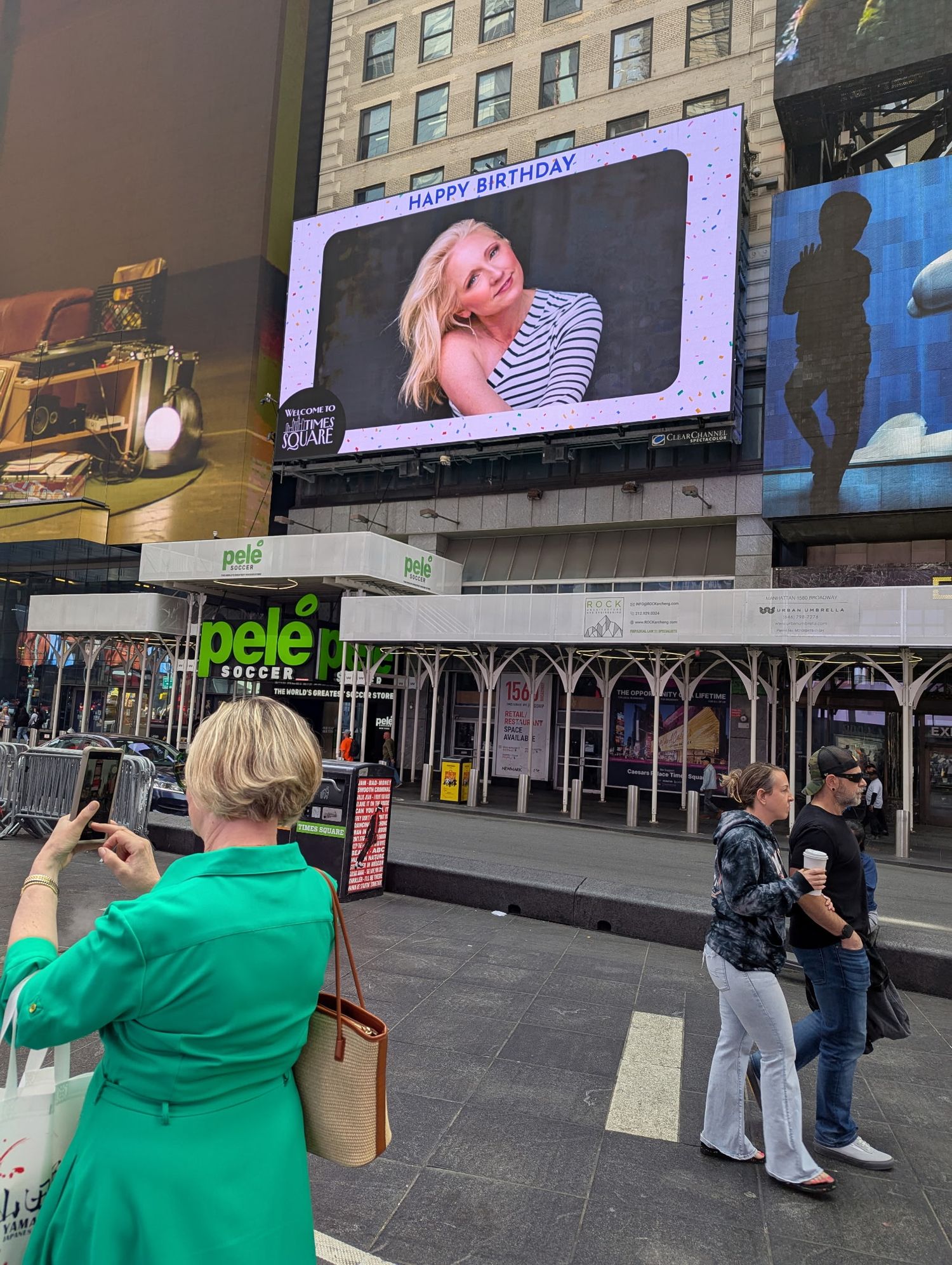 Series of photos showing people taking pictures of digital billboards in an urban setting.