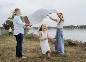 child running through field during family session, family portrait photographer Moncton New Brunswick candid moment photography
