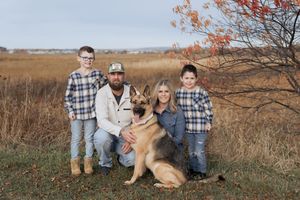Family poses in a grassy field in Dieppe New Brunswick, fall family photography in Moncton, lifestyle portrait photographer near me