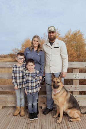 Family poses on boardwalk in Moncton New Brunswick photographer, family portraits, fall lifestyle photography outside with german shepherd