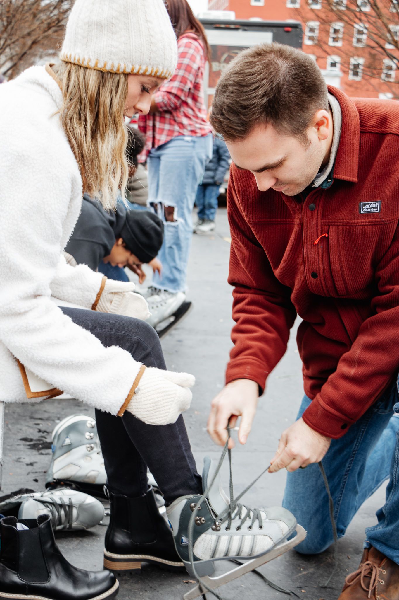 Ice Skating Adventure Photography Session | Husband helping lace up ice skates on wife | K Murphy Photos | Roanoke, Virginia