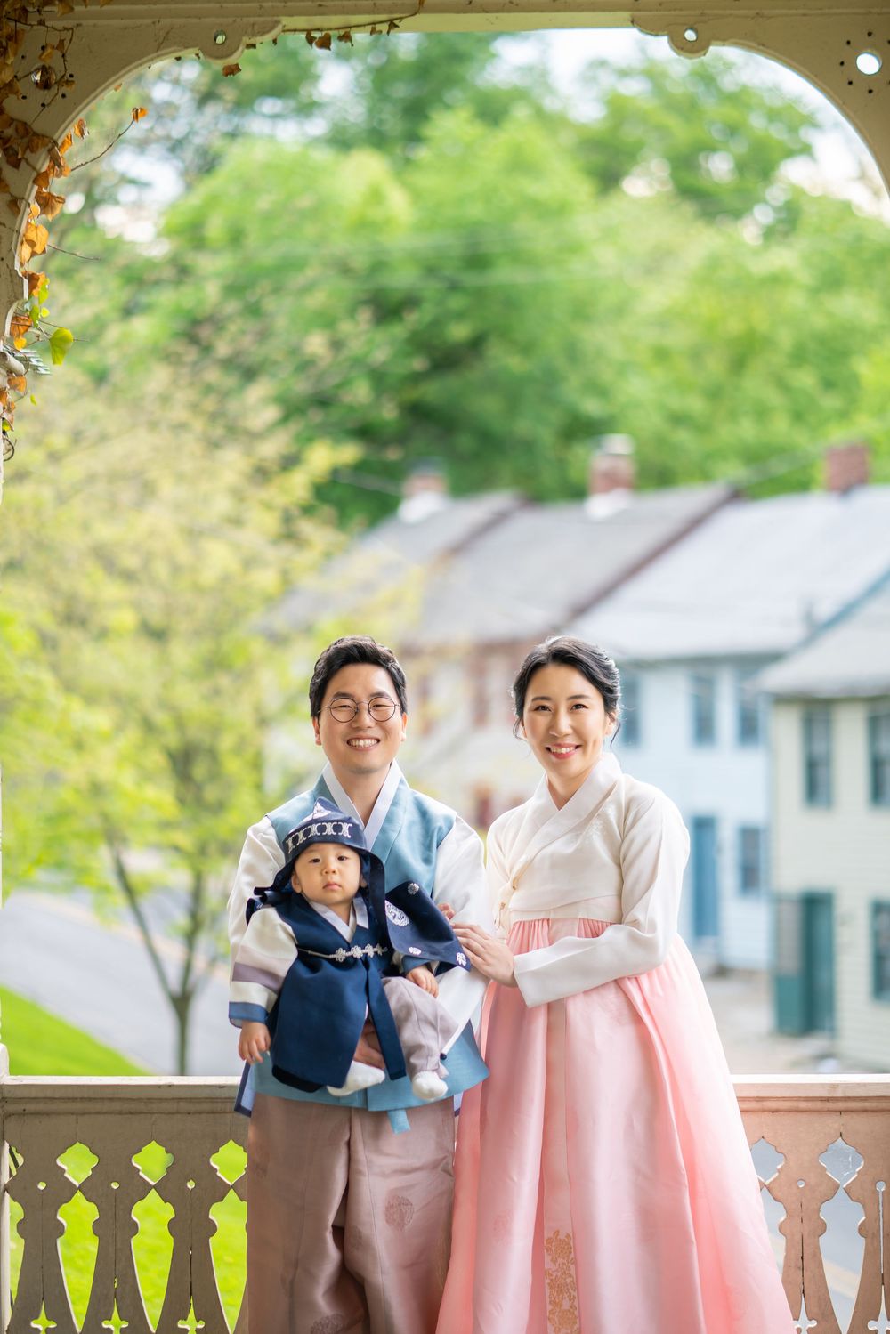 A traditional Korean scene on a sunlit porch with traditional hanbok clothing and soft spring colors.