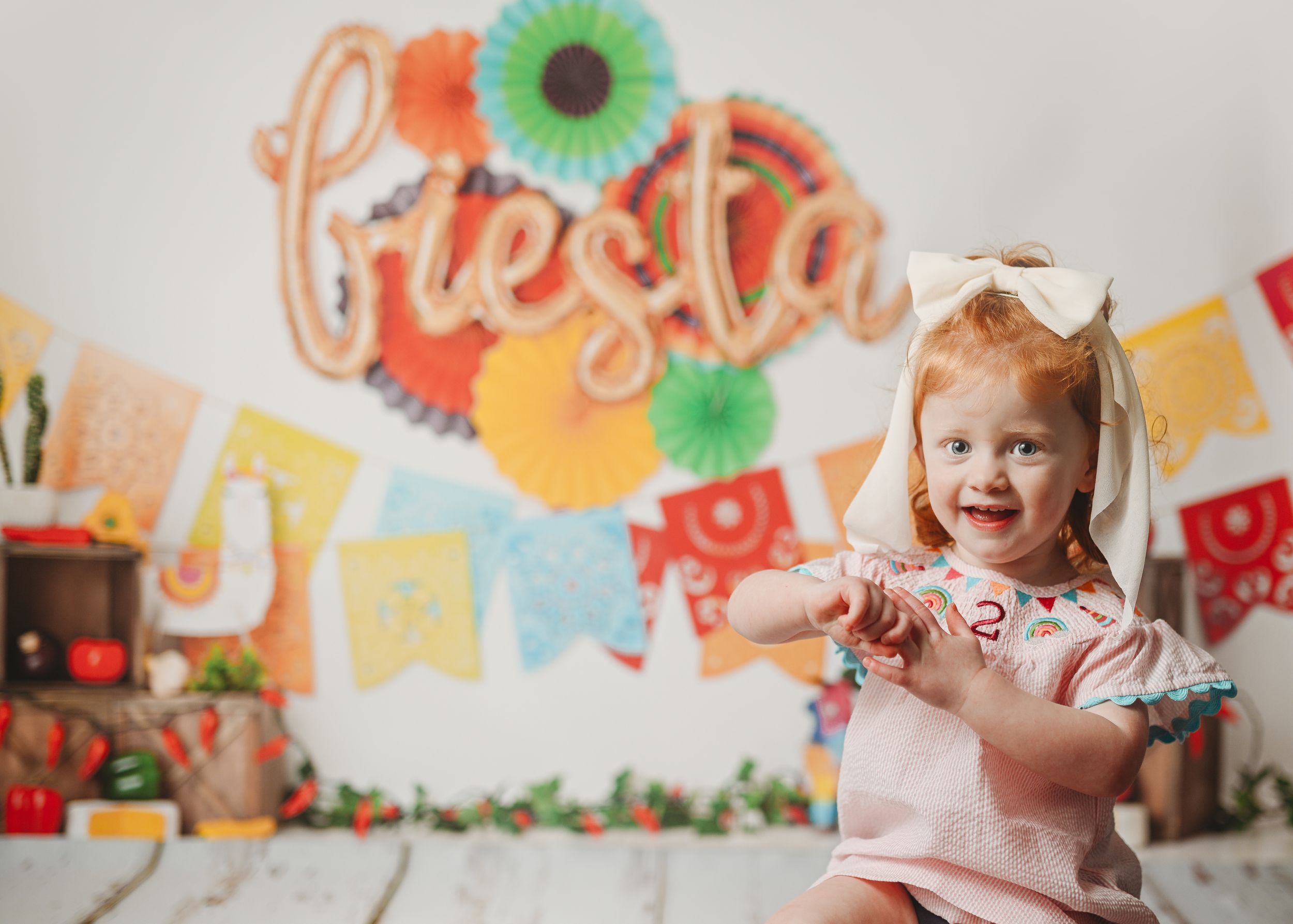 Colorful birthday party setup with paper flowers and festive decorations.