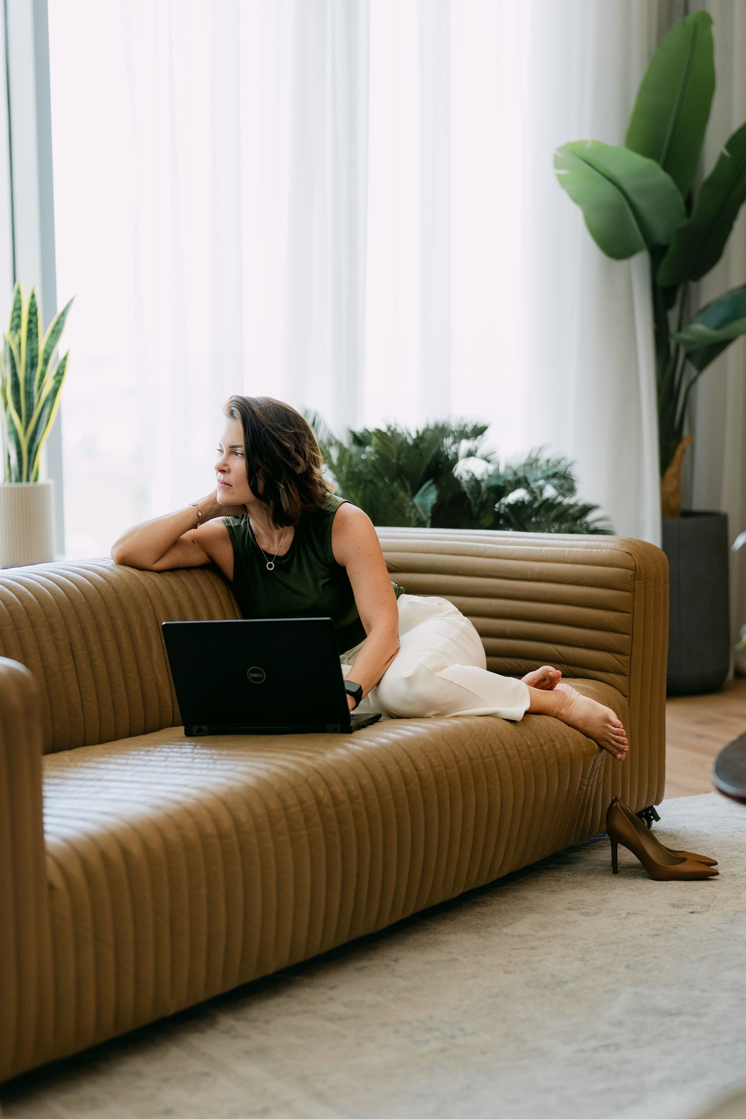 Studio personal branding photoshoot in Dubai – professional woman on sofa with plants