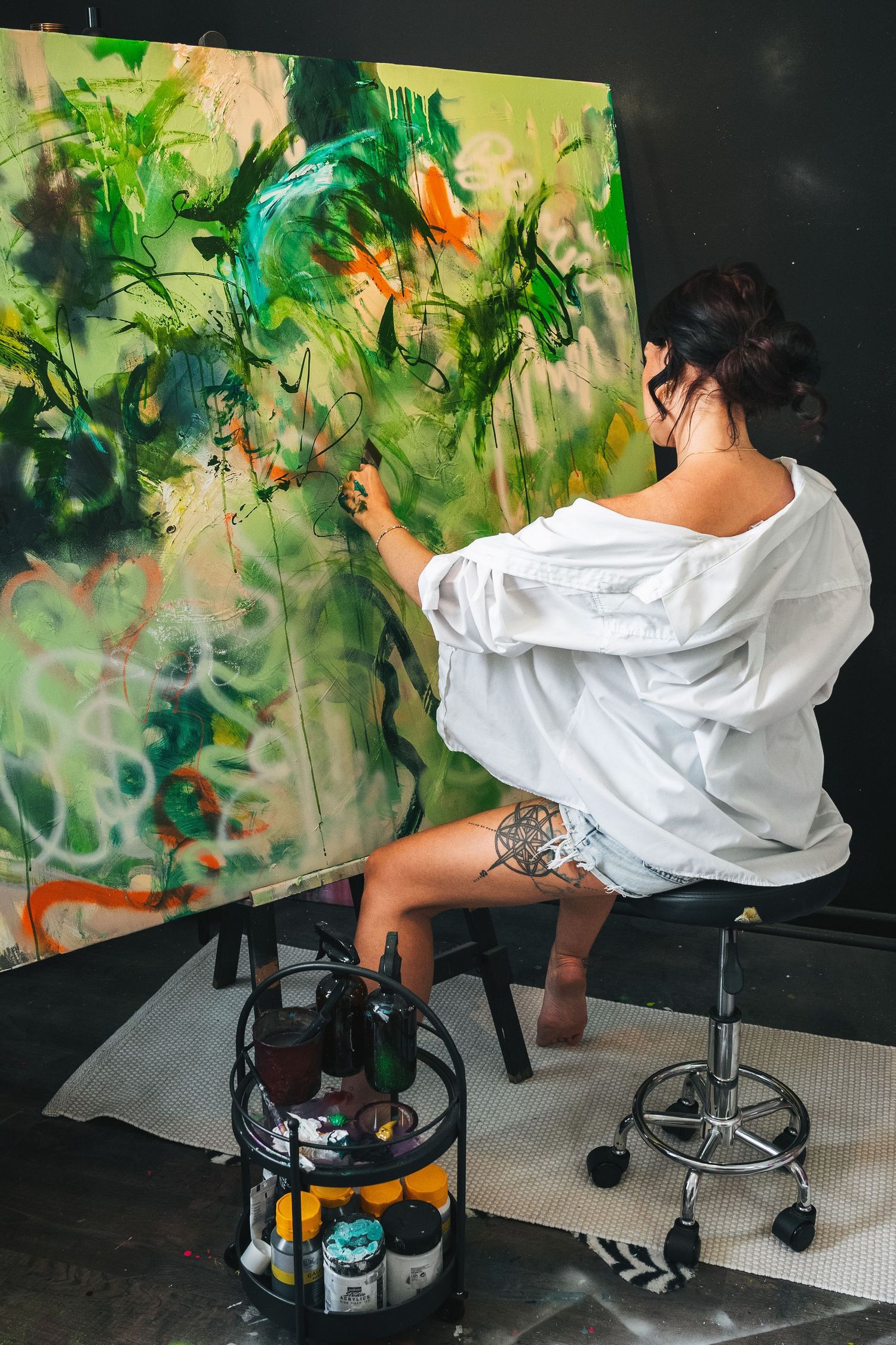 Lifestyle personal branding portrait of painter in her workspace