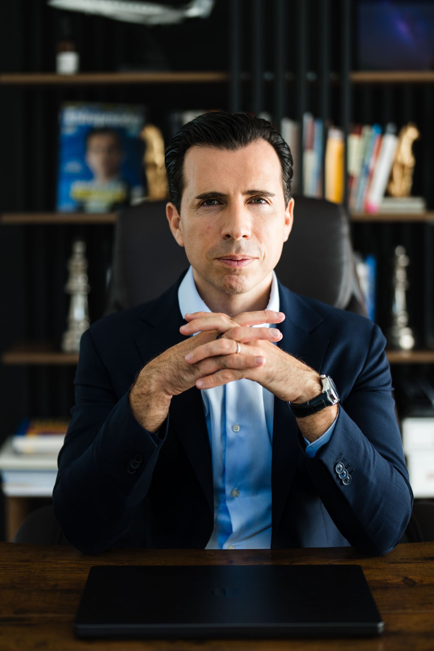 Confident entrepreneur portrait with dramatic office backdrop