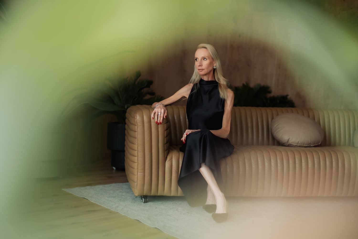 Studio personal branding photoshoot in Dubai – woman seated on modern sofa, light background