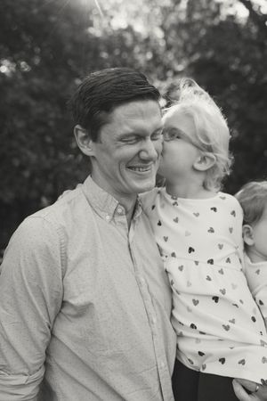 A series of candid black and white photos showing joyful expressions and laughter between two people outdoors.