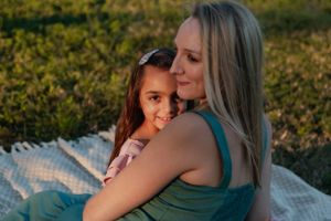 Intimate outdoor portrait on a blanket during golden hour.