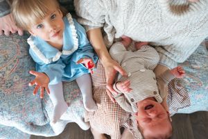 Sequence of photos showing tender moments between a baby and caregiver on white bedding.