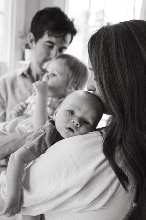 Black and white photo series capturing gentle family interactions and embraces.