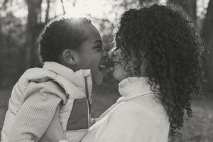 A series of black and white photographs showing intimate family moments of affection and play.