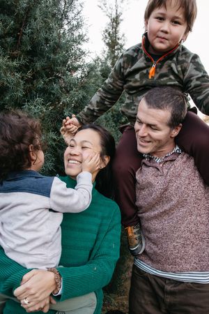 A playful sequence of candid family moments captured outdoors showing joyful interaction and laughter.