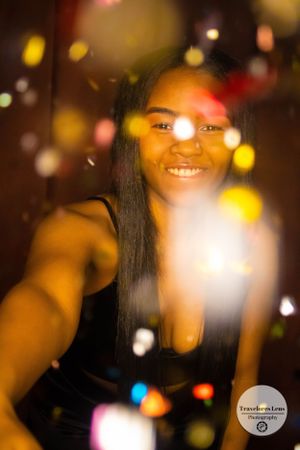 Colorful bokeh lights create dreamy effect in portrait photo with warm glowing atmosphere.