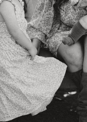 A black and white close-up of floral dresses and casual clothing details.