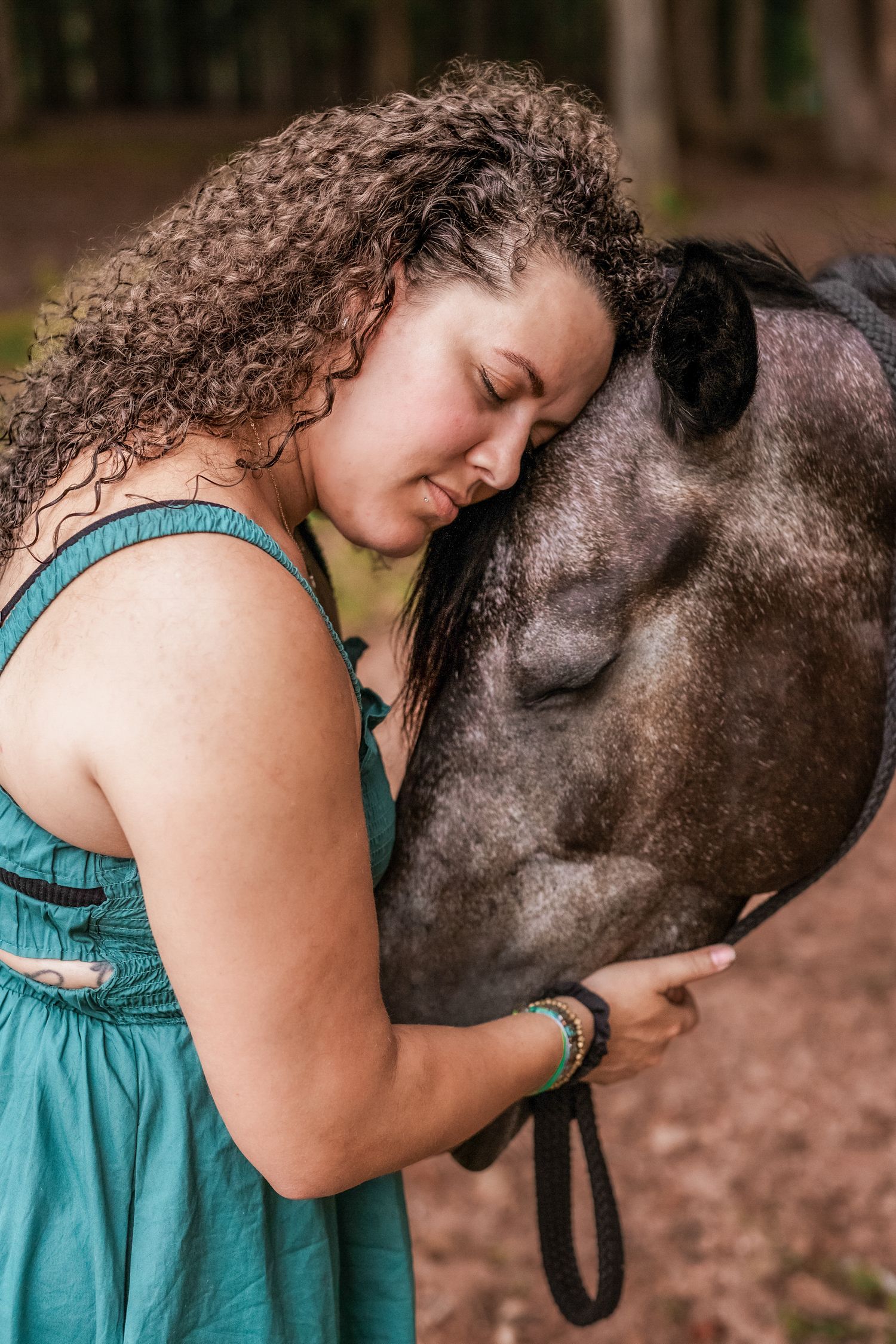 Woman hugging her horse in a peaceful Windsor outdoor setting, capturing a deep bond and love.