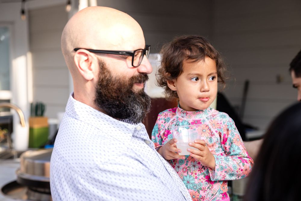 Father and child sharing a moment together at an outdoor event.