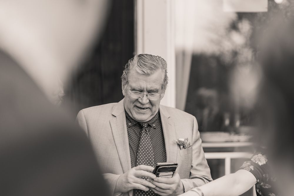 A sequence of black and white photos shows someone drinking coffee and looking at a smartphone at a table.