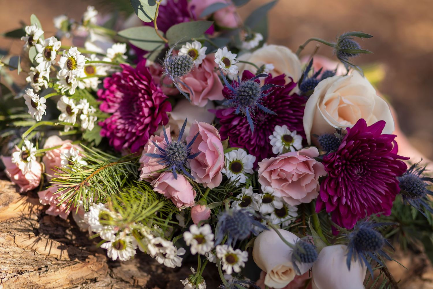Bridal bouquet of reds, purples, pinks, green, and white