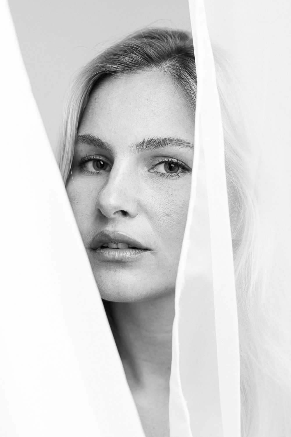 A black and white artistic portrait series showing different angles and cropped views of the same face.
