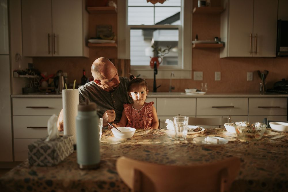 Person baking in a rustic kitchen with golden sunlight streaming through the window.