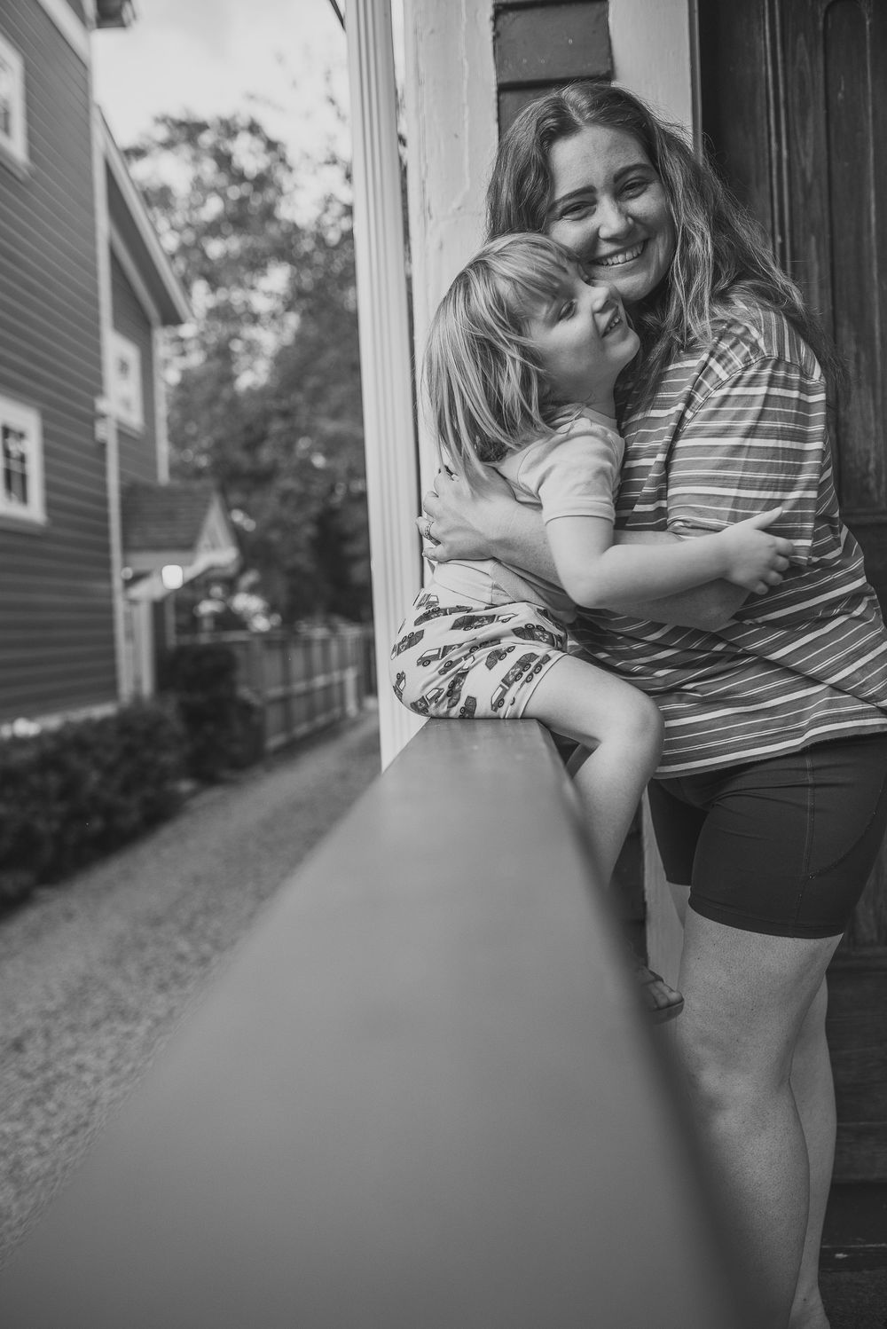 A series of black and white images showing an intimate embrace between two people on a porch.