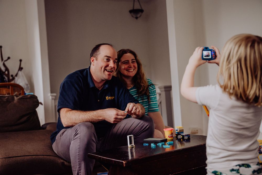 People gathered around a table in a cozy indoor setting sharing a casual moment together.