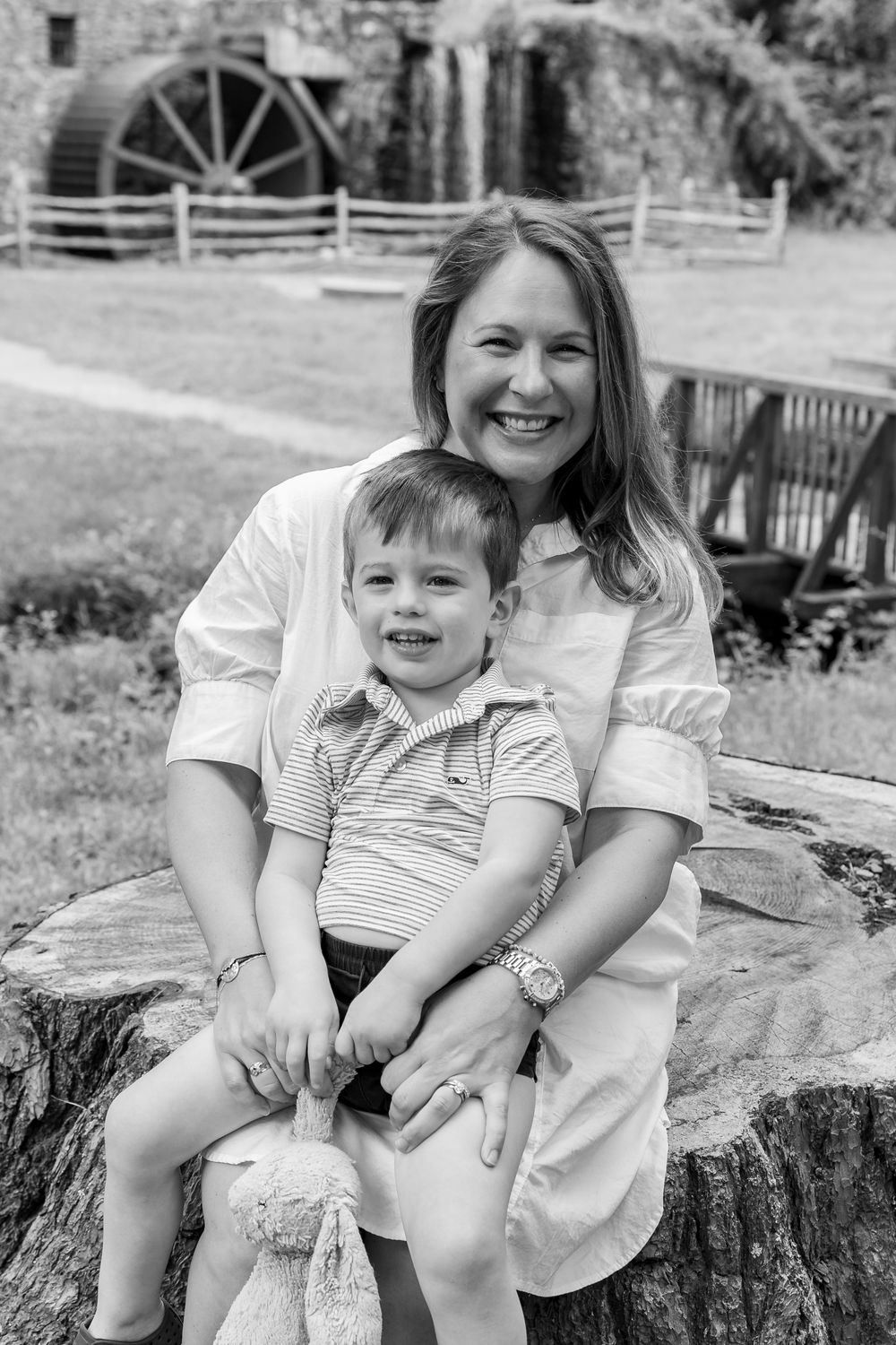 A mom & son pose candidly on the grounds of Wayside Inn Grist Mill during a family photos outside  Boston, MA with Lisa West Photography.