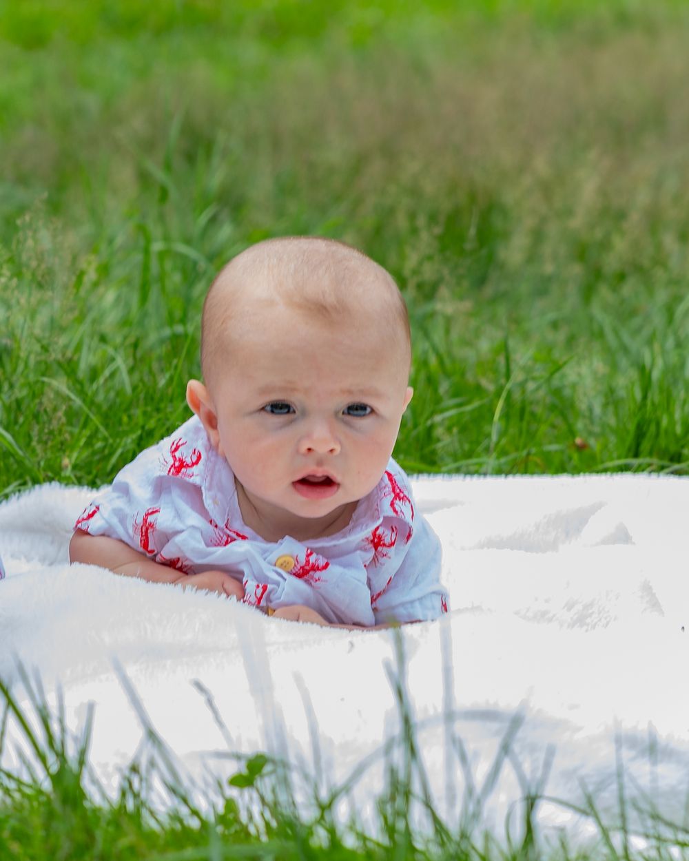 A baby boy poses at the Wayside Inn Grist Mill during a family photo session outside Boston with Lisa West Photography.