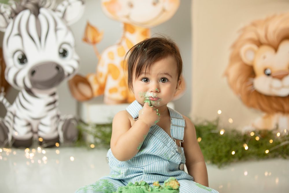First birthday cake smash Ipswich and Brisbane – baby girl in jungle-themed setup with zebra and lion decor, Springfield Lakes studio portra