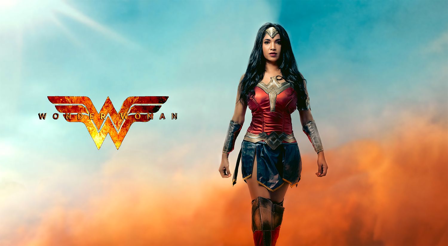 A superhero stands in a dramatic pose against a turquoise and orange sky with the Wonder Woman logo above.