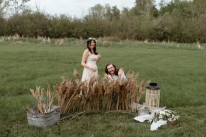 A playful moment among dried pampas grass arrangements in a green field.