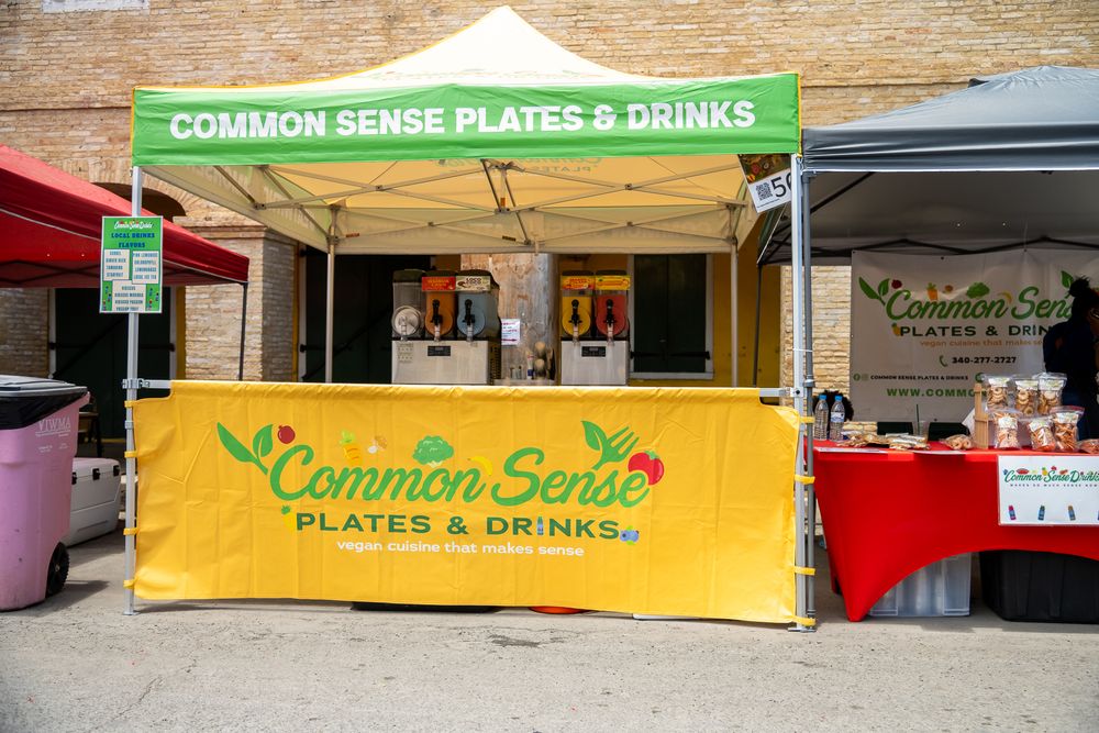 Exterior view of Common Sense restaurant storefront with green signage and yellow awning.