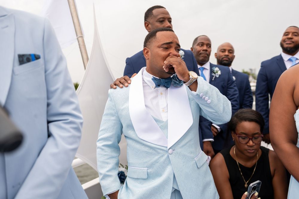 Kids and family members wearing shades of blue at yacht wedding ceremony